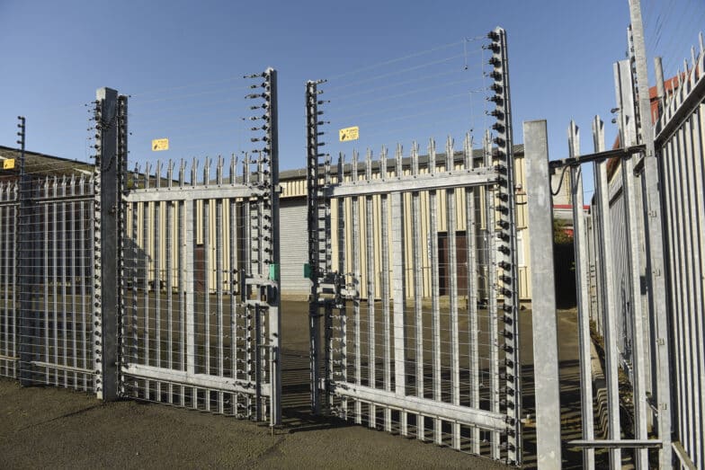 High-security electric gates with warning signs